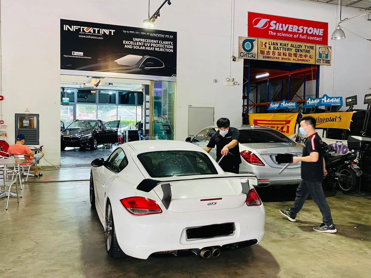 White Porsche GTS coupe during window tinting at Infratint Singapore