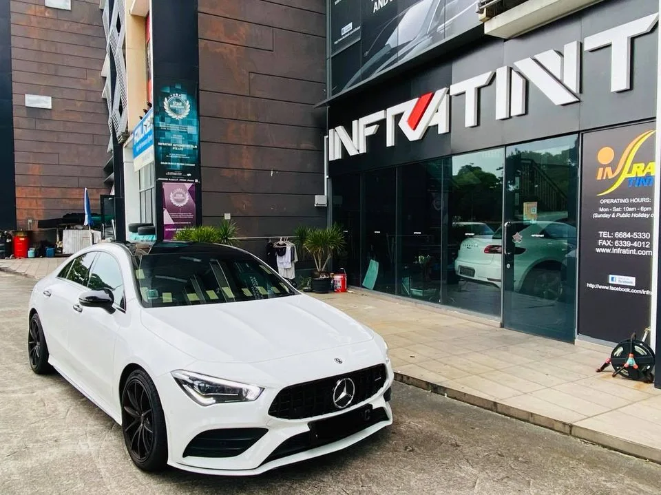 White Mercedes-Benz CLA parked outside the Infratint Singapore shopfront after window tinting