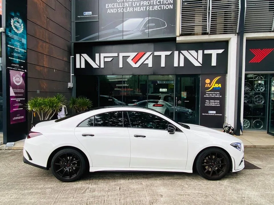 White Mercedes-Benz CLA side profile outside Infratint Singapore showing tinted windows