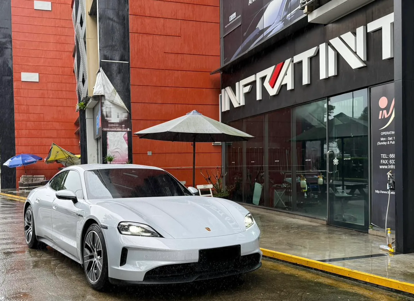 Light grey Porsche Taycan front three-quarter view outside Infratint Singapore