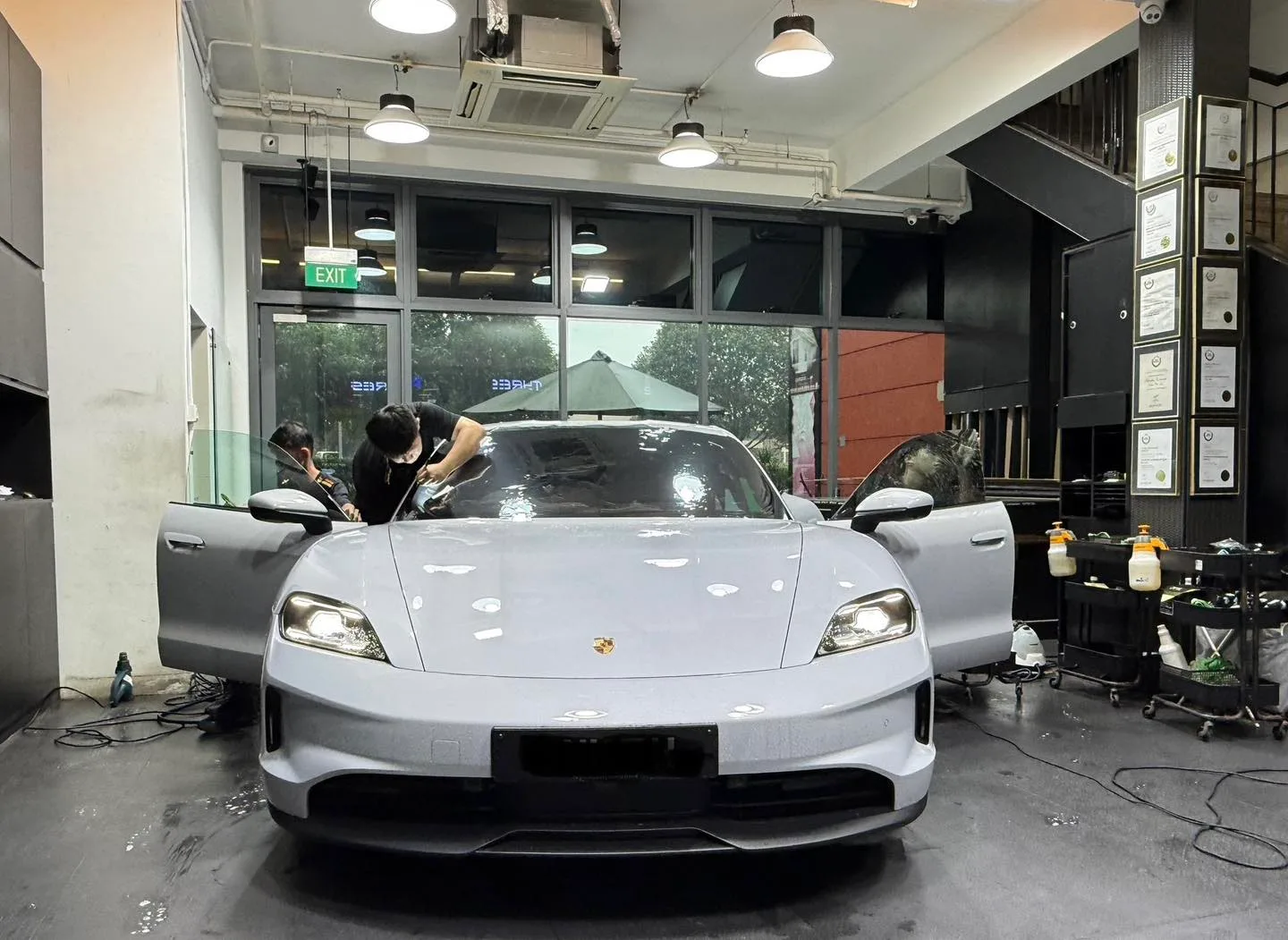 Porsche Taycan front view inside Infratint Singapore workshop during windscreen film install