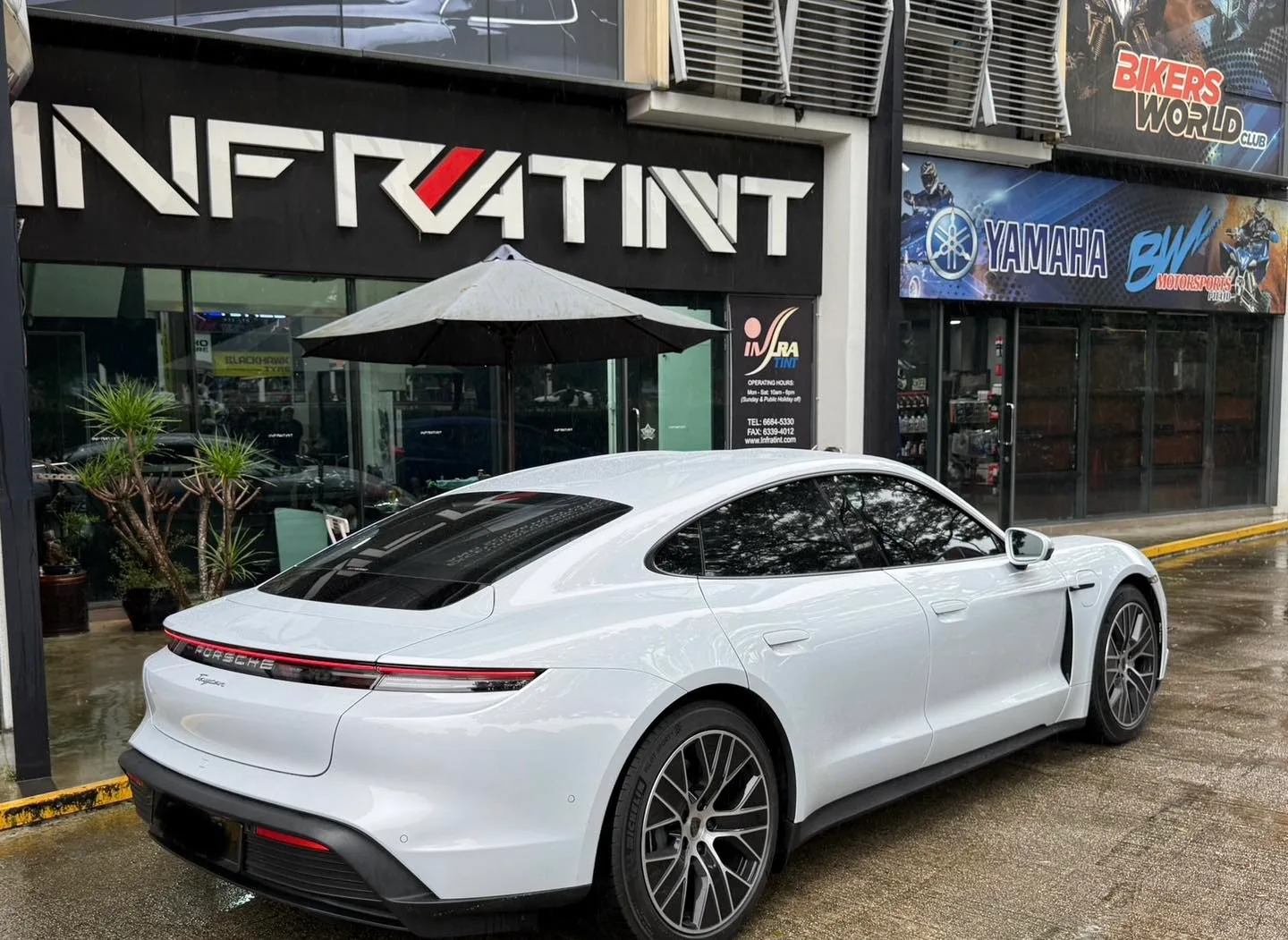Light grey Porsche Taycan rear three-quarter with tinted glass at Infratint Singapore