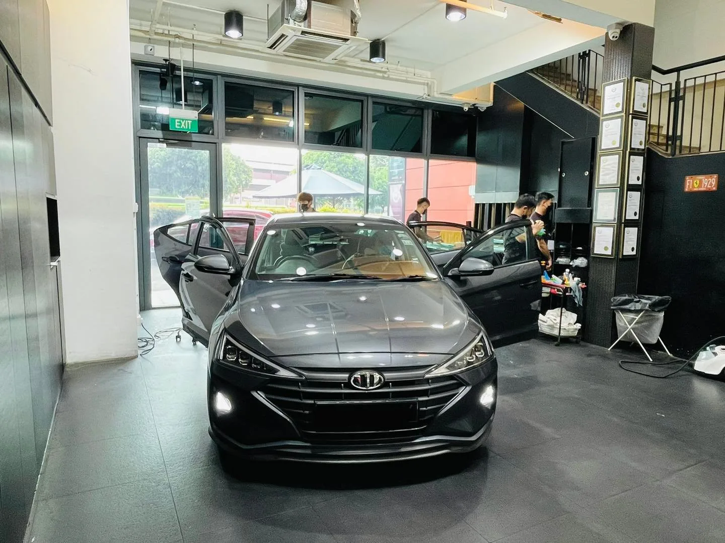 Front view of a grey Hyundai sedan during window film install at Infratint Singapore