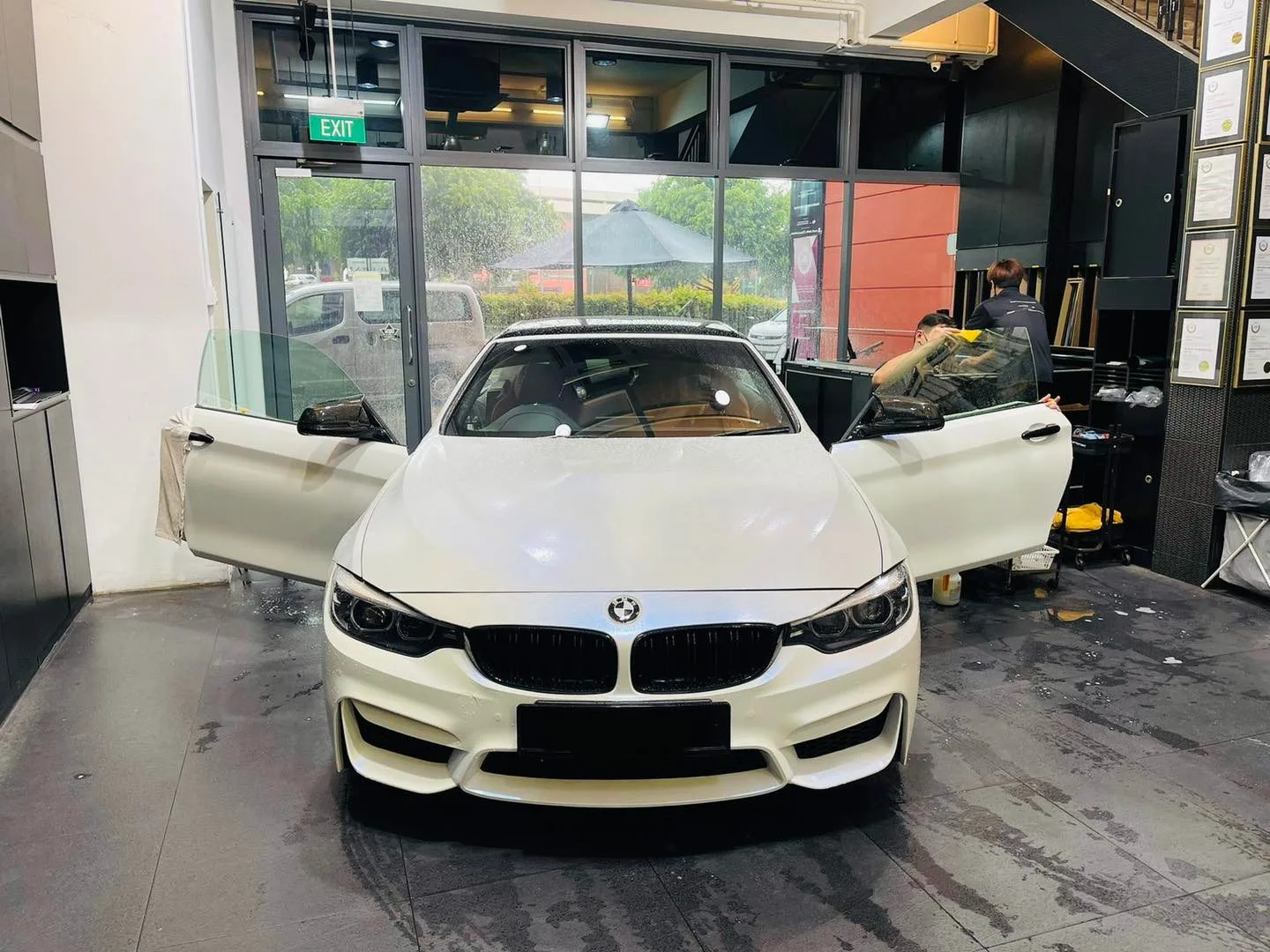 White BMW sedan with doors open getting windows tinted at Infratint Singapore