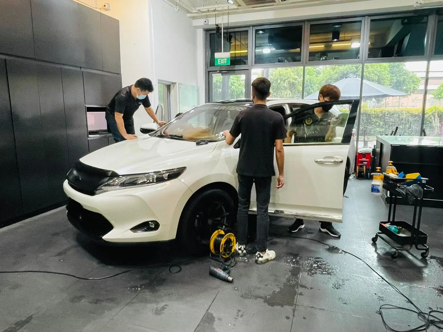 White Toyota SUV being tinted by three technicians at Infratint Singapore