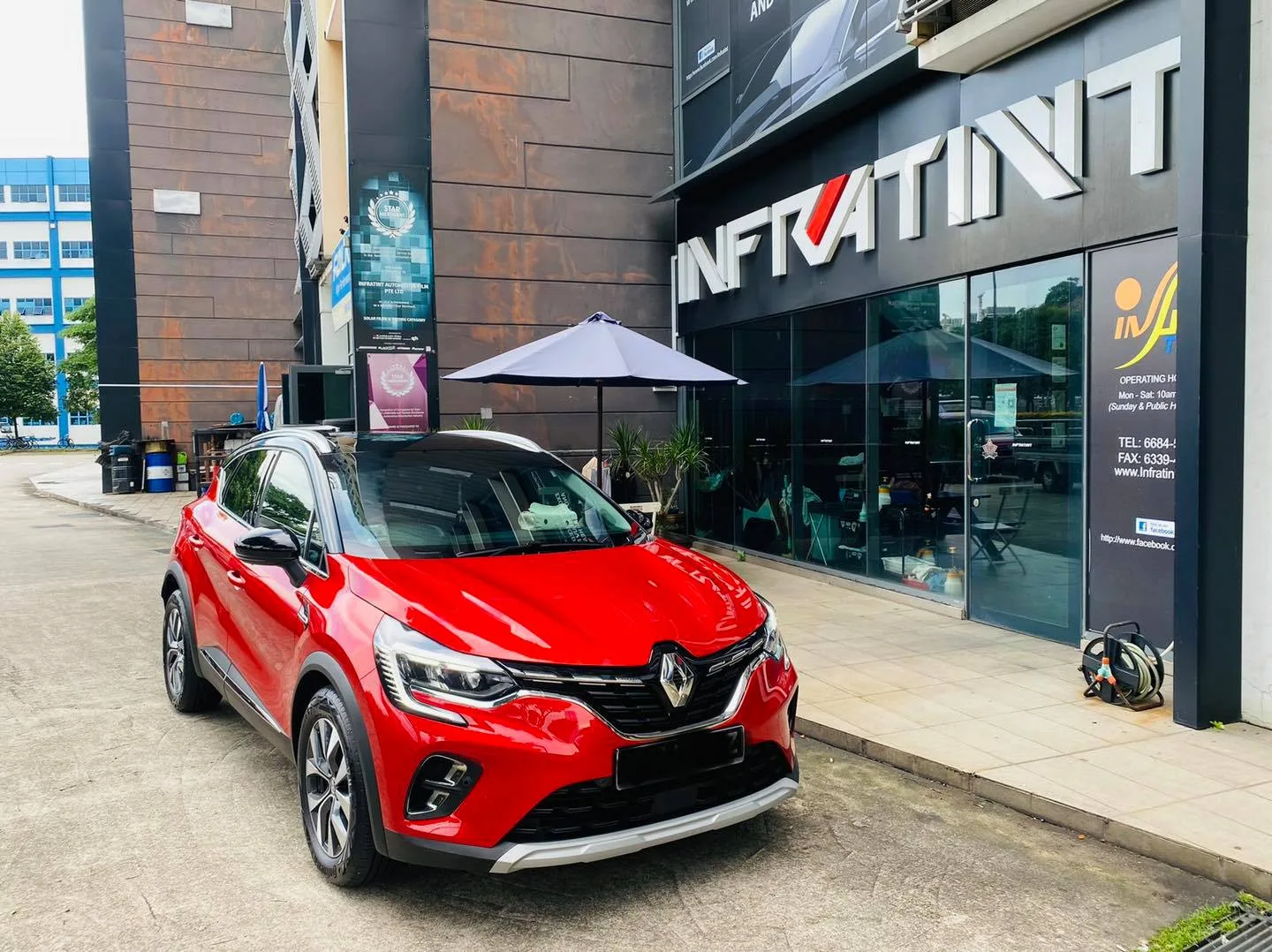 Red Renault Captur parked outside Infratint Singapore after window tinting