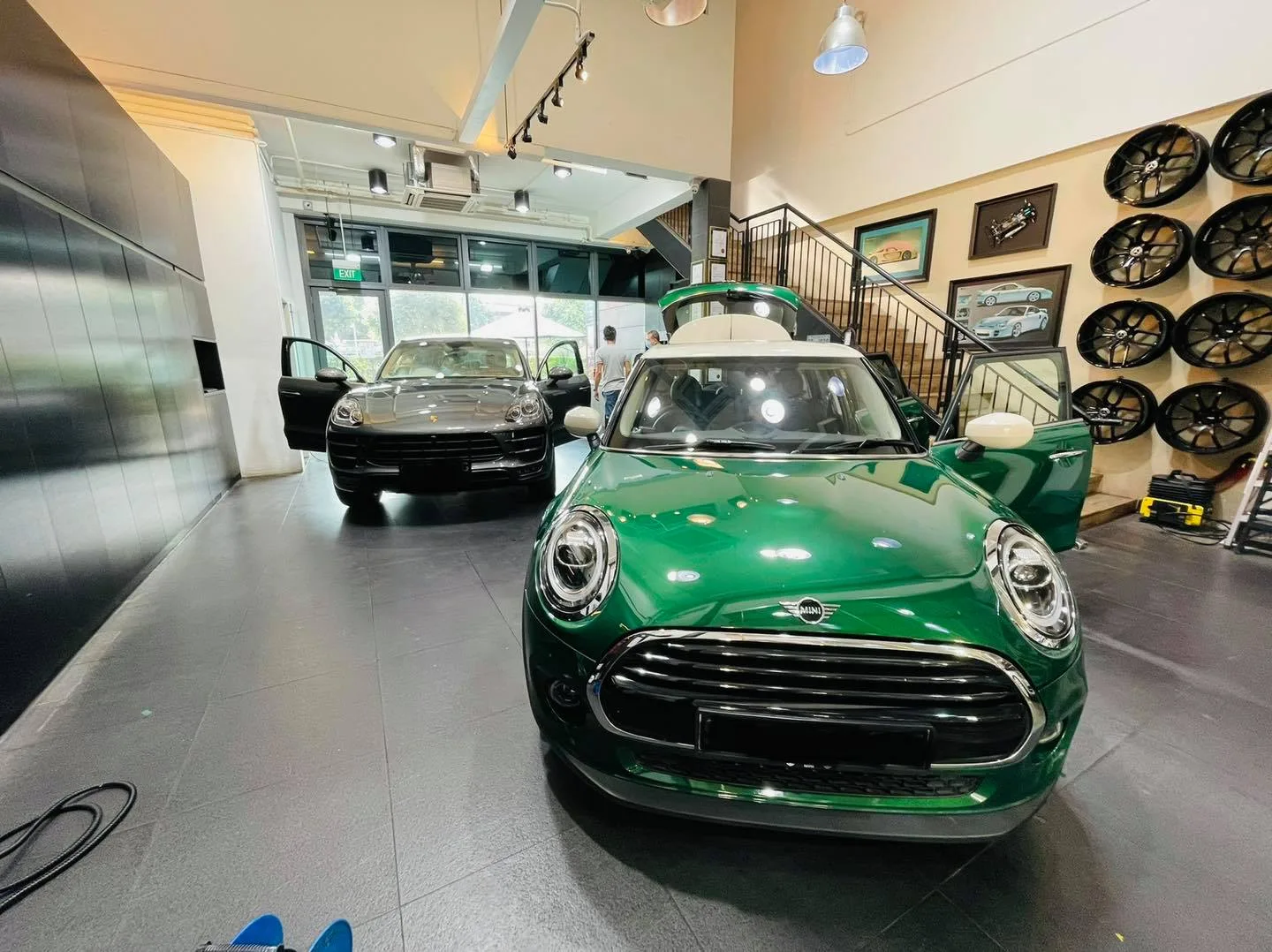 Green Mini Cooper and grey Porsche inside the Infratint Singapore showroom for window tinting