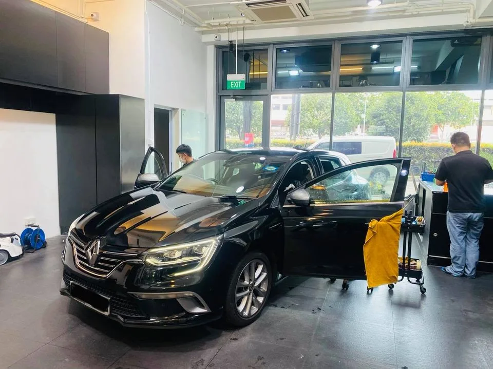 Black Renault Megane during window tinting at Infratint Singapore