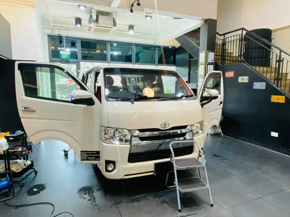 White Toyota Hiace van in for window film installation at Infratint Singapore