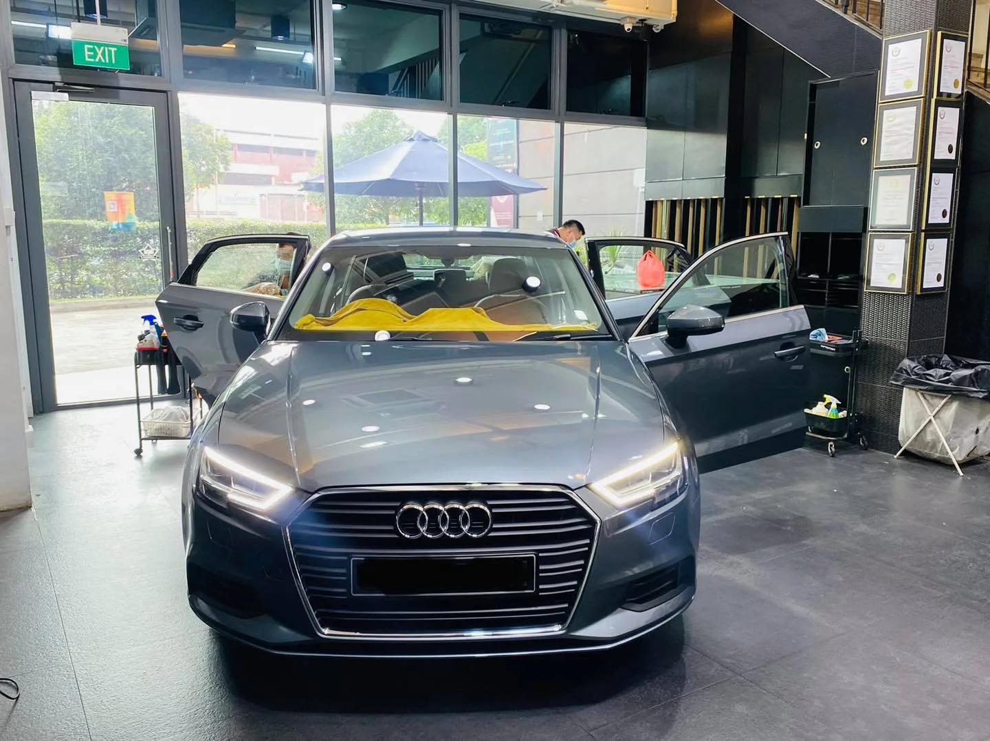Grey Audi A3 sedan front view during tinting at Infratint Singapore