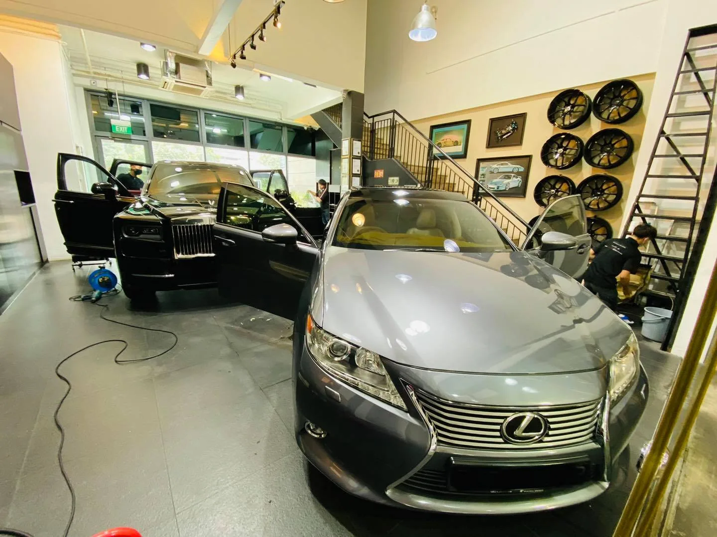Grey Lexus ES and a dark Rolls-Royce Cullinan inside the Infratint Singapore bay