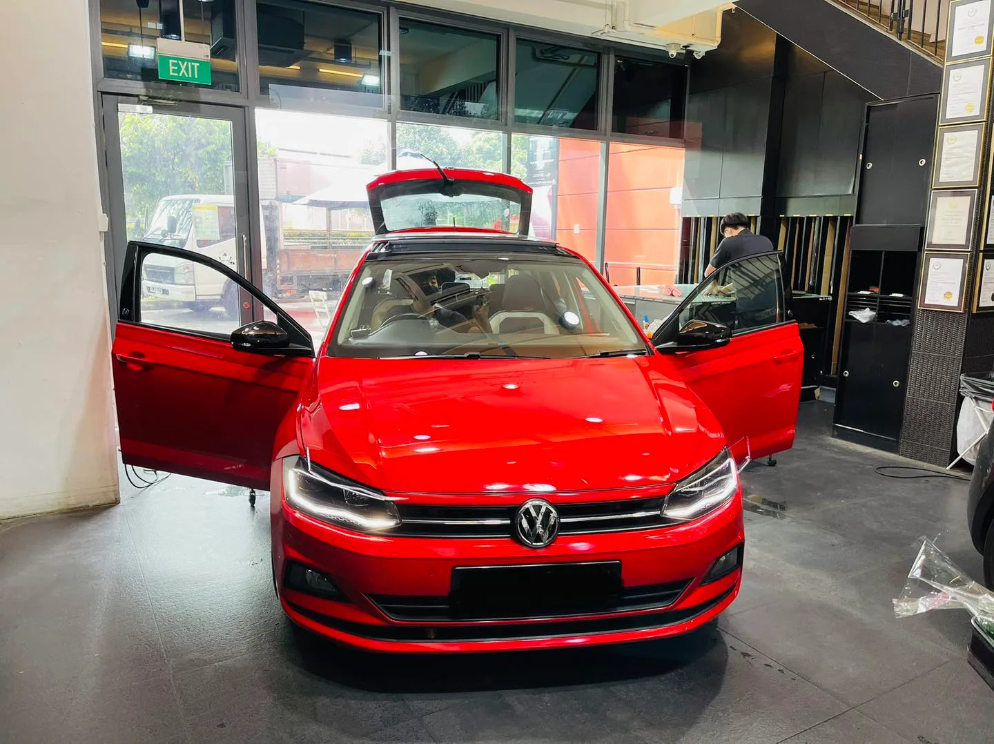Red Volkswagen hatch with doors and tailgate open during tinting at Infratint Singapore