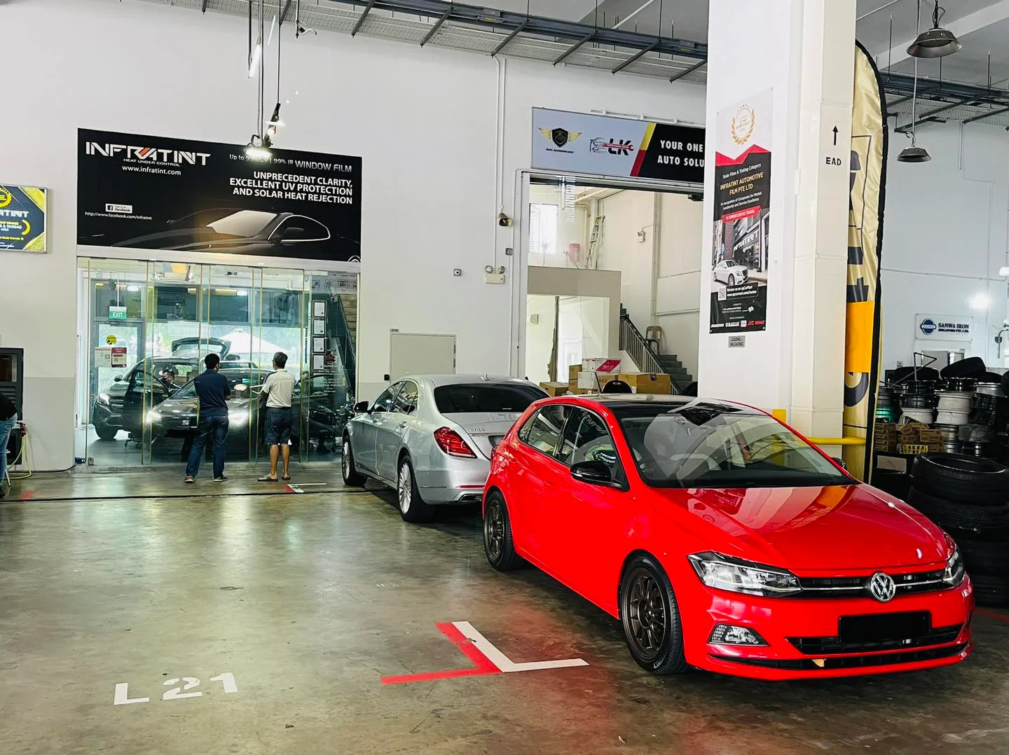 Red Volkswagen hatch and silver Mercedes at Infratint Singapore