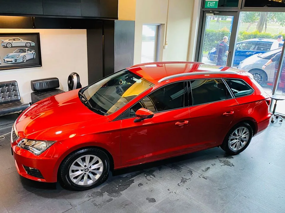 Red SEAT Leon estate in side profile at Infratint Singapore for window tinting