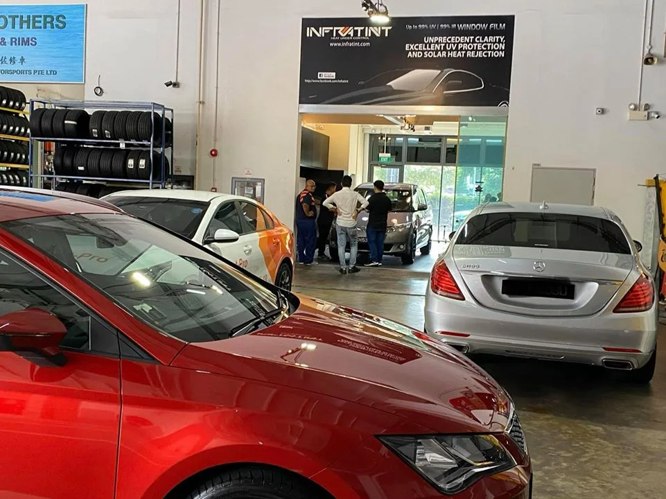 Red SEAT Leon and silver Mercedes-Benz S-Class inside the Infratint Singapore workshop