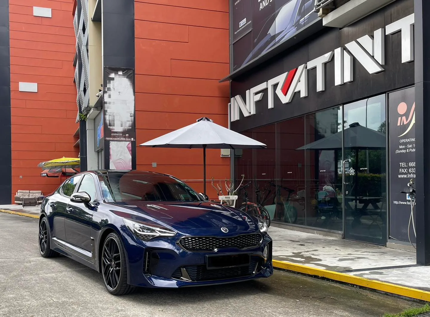 Dark blue Kia Stinger GT front three-quarter view with tinted windows at Infratint Singapore