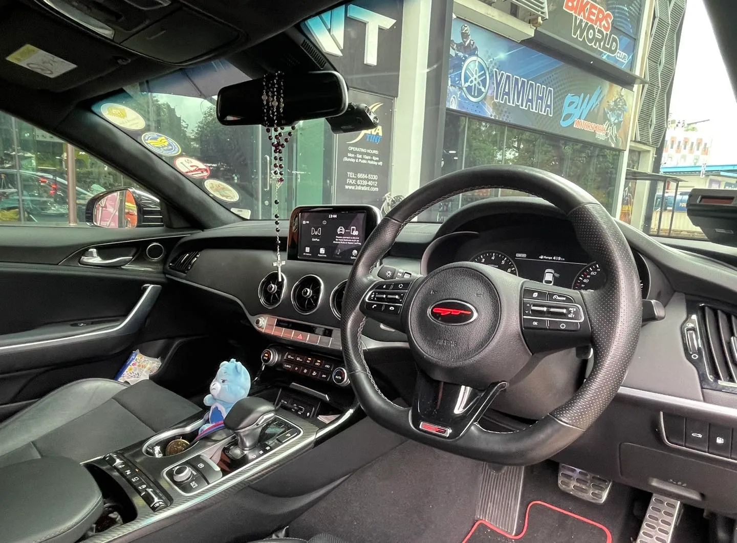 Kia Stinger GT interior with steering wheel and dashboard seen through tinted glass at Infratint Singapore