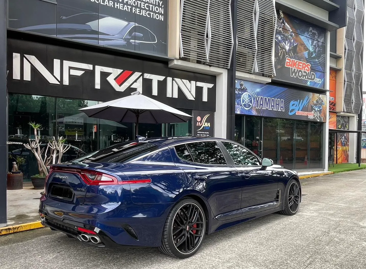 Dark blue Kia Stinger GT rear three-quarter view with tinted glass at Infratint Singapore