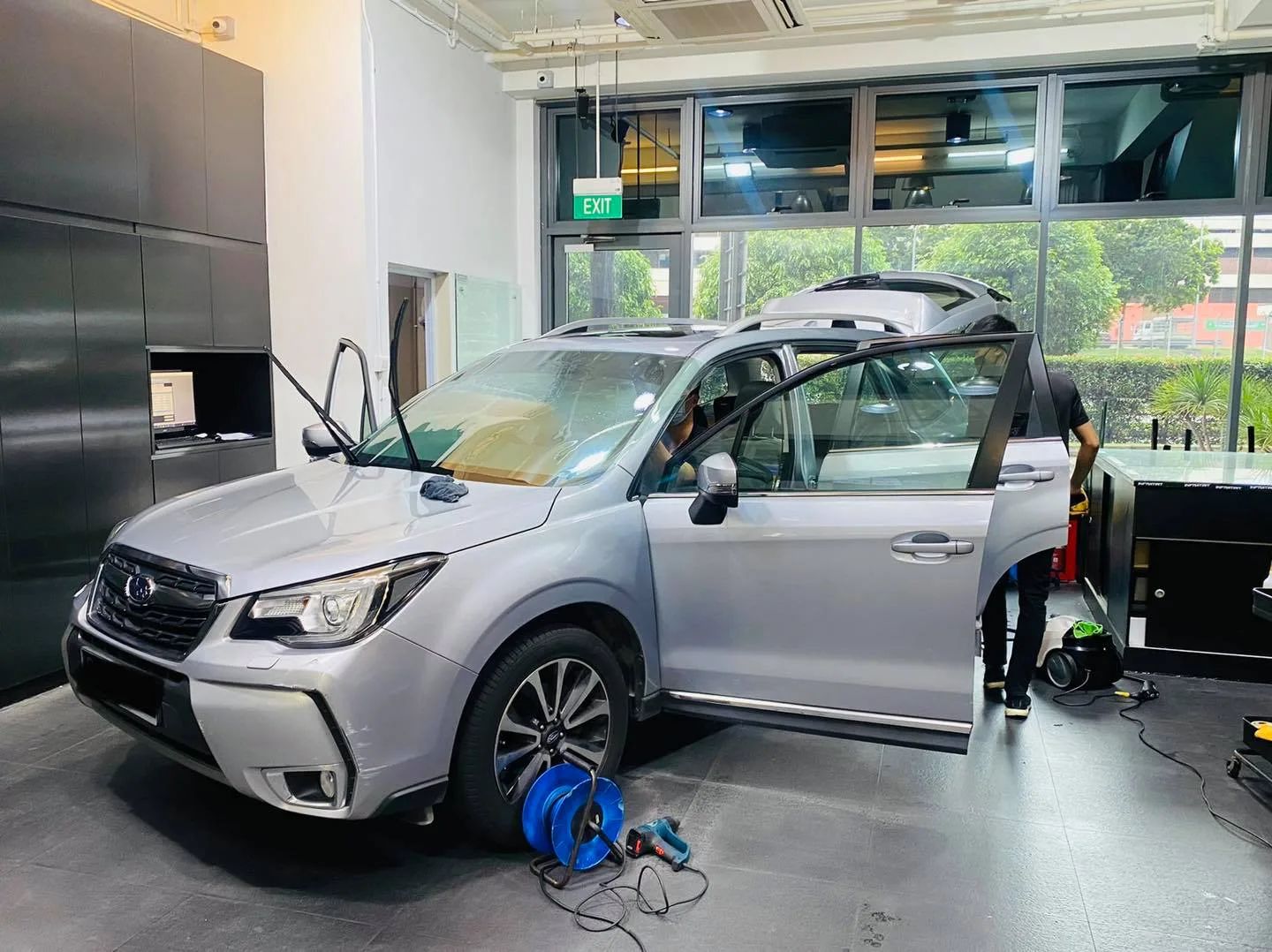 Silver Subaru Forester in three-quarter view during window tinting at Infratint Singapore