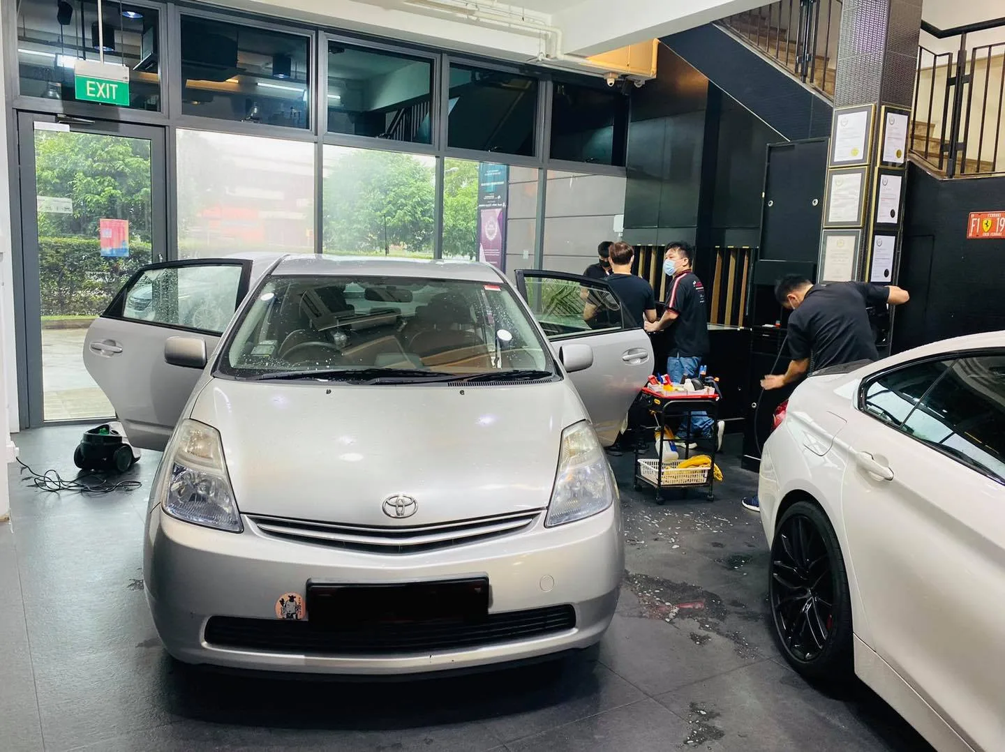 Silver Toyota Prius with doors open during window tinting at Infratint Singapore