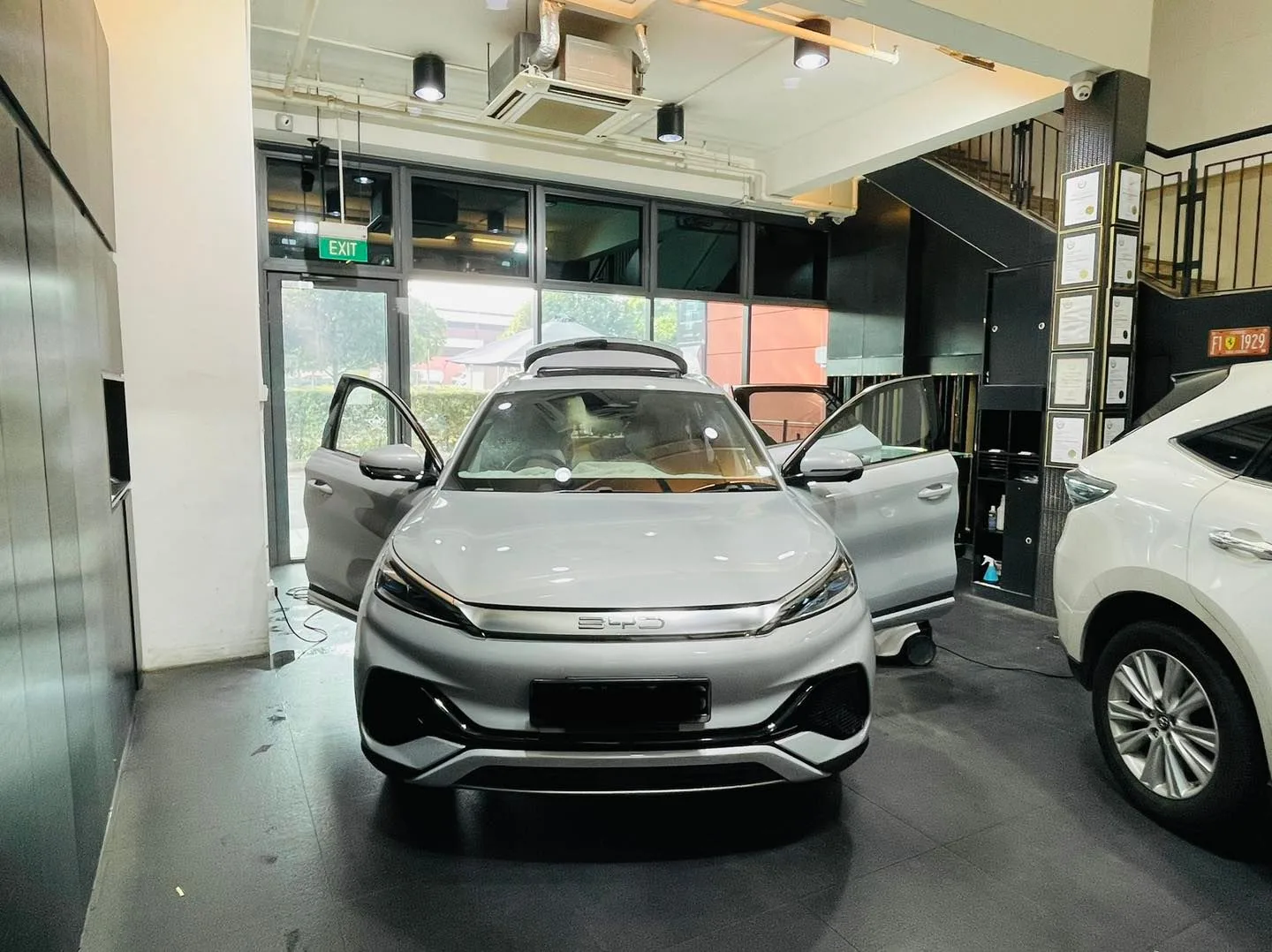 Silver BYD Atto 3 electric SUV with doors open during window film install at Infratint Singapore