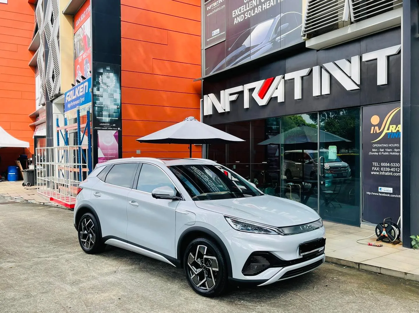 Silver BYD Atto 3 parked outside the Infratint Singapore shopfront after window tinting