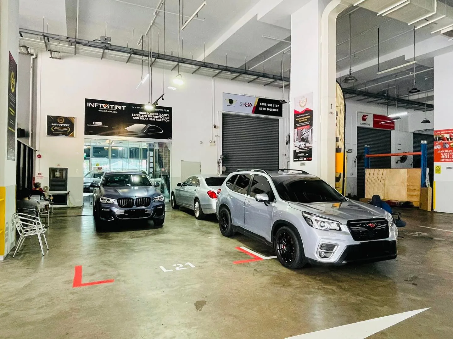Silver Subaru Forester and BMW X4 lined up at Infratint Singapore window tinting workshop