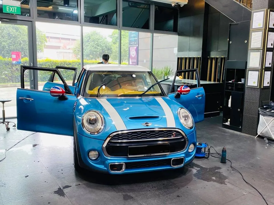 Blue Mini Cooper S with Union Jack mirror caps and doors open at Infratint Singapore