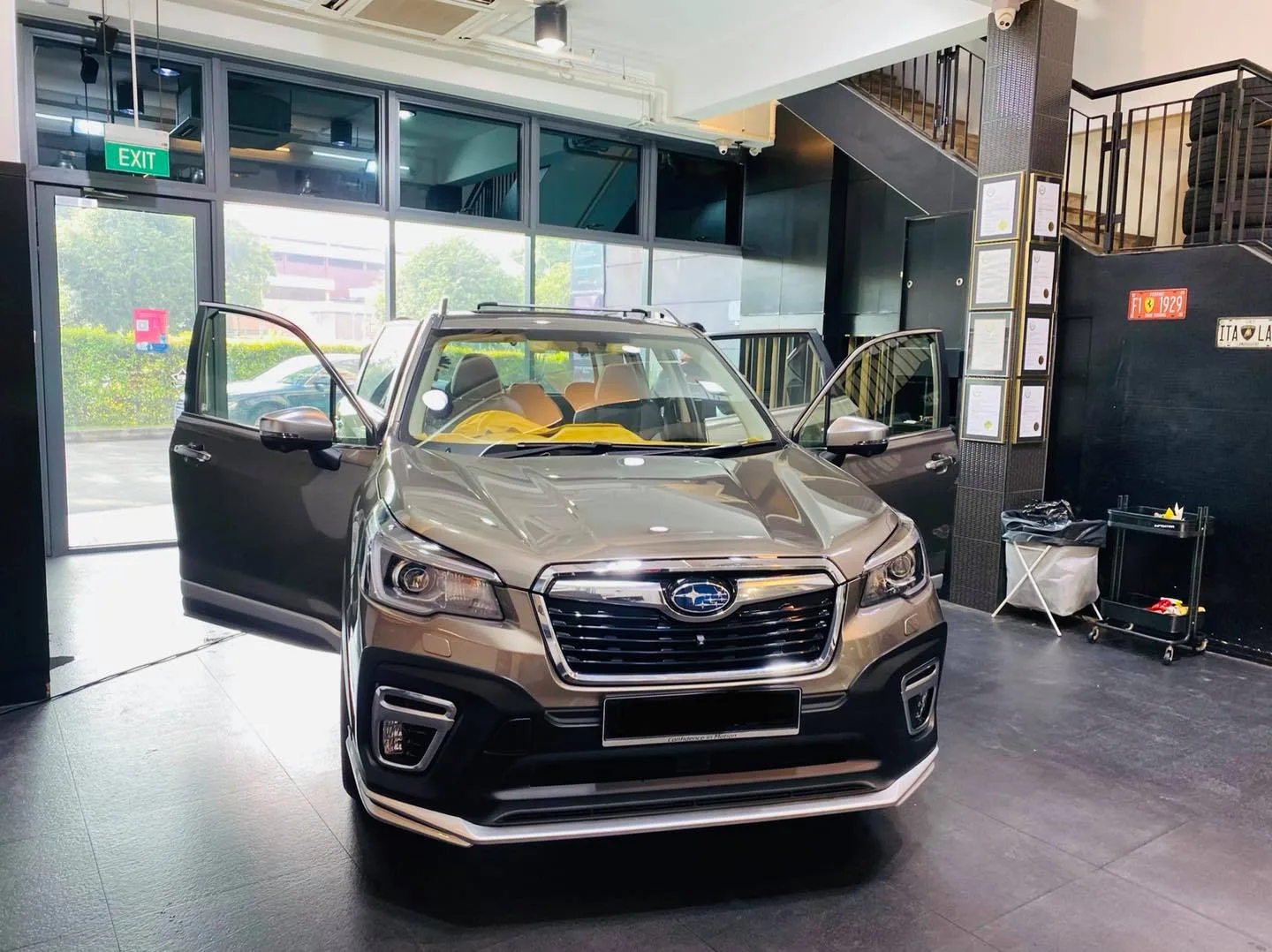 Bronze Subaru Forester SUV with doors open for window tinting at Infratint Singapore