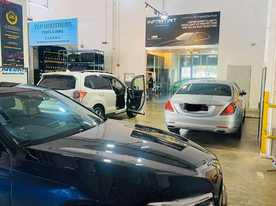 White Subaru Forester and silver Mercedes-Benz inside the Infratint Singapore workshop