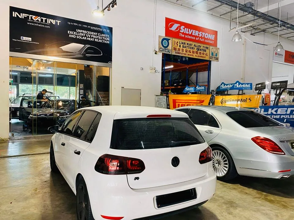 White Volkswagen Golf R and silver Mercedes-Benz at Infratint Singapore for window tinting