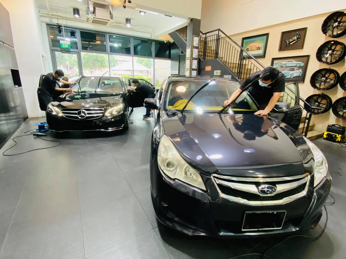 Black Subaru sedan and black Mercedes-Benz sedan being tinted at Infratint Singapore