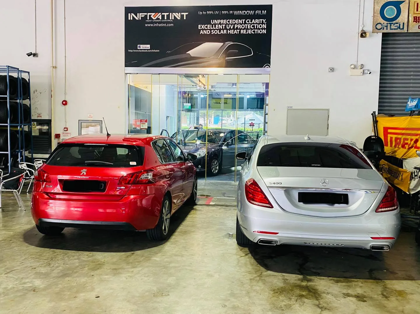 Red Peugeot and silver Mercedes-Benz sedan in the install bay at Infratint Singapore