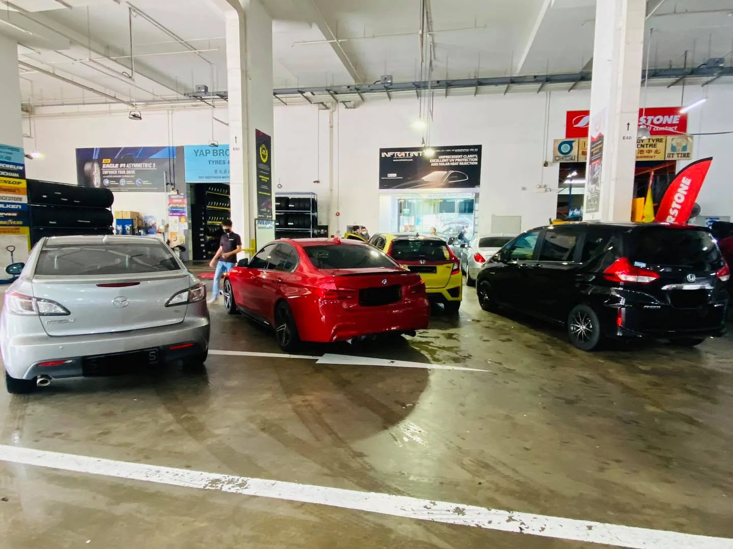 Silver Mazda6, red BMW sedan and black Honda parked at Infratint Singapore