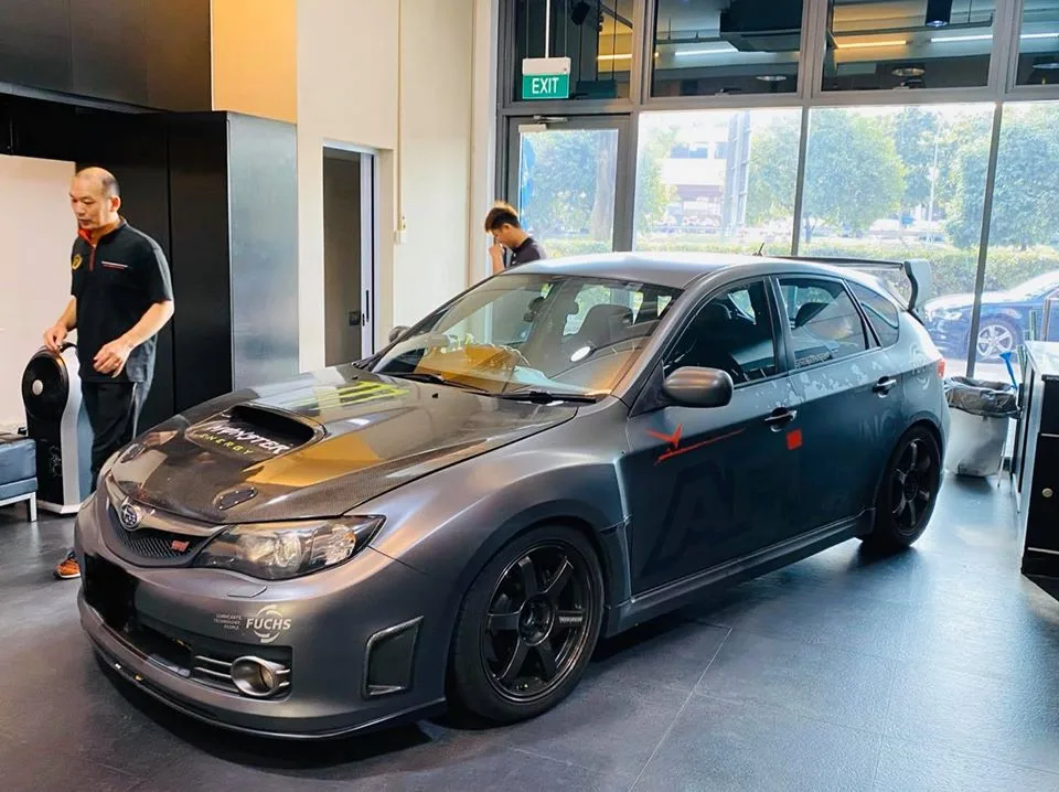 Side profile of a grey Subaru WRX STI hatchback at Infratint Singapore before window tinting