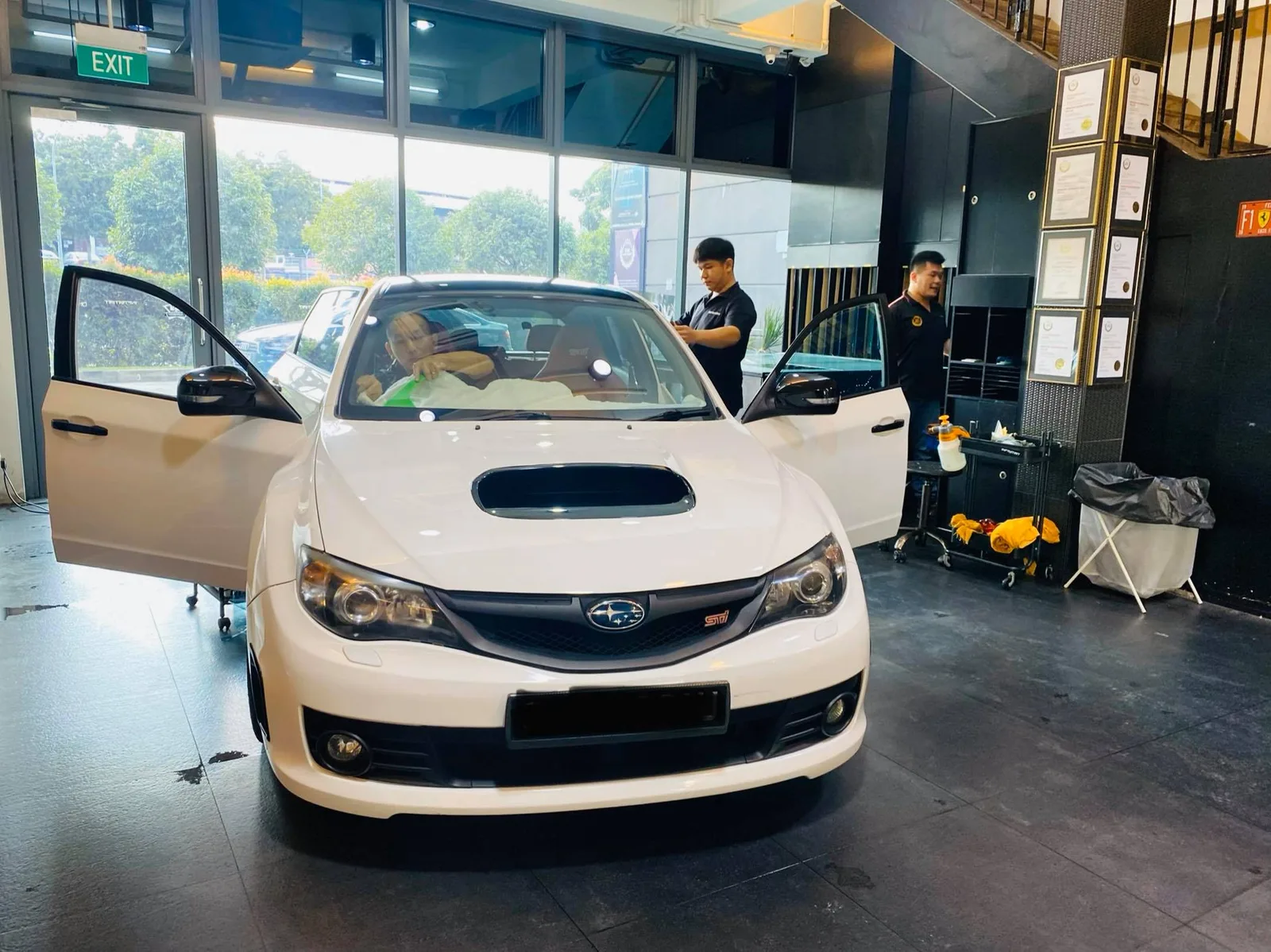 White Subaru WRX STI front view with hood scoop during window tinting at Infratint Singapore