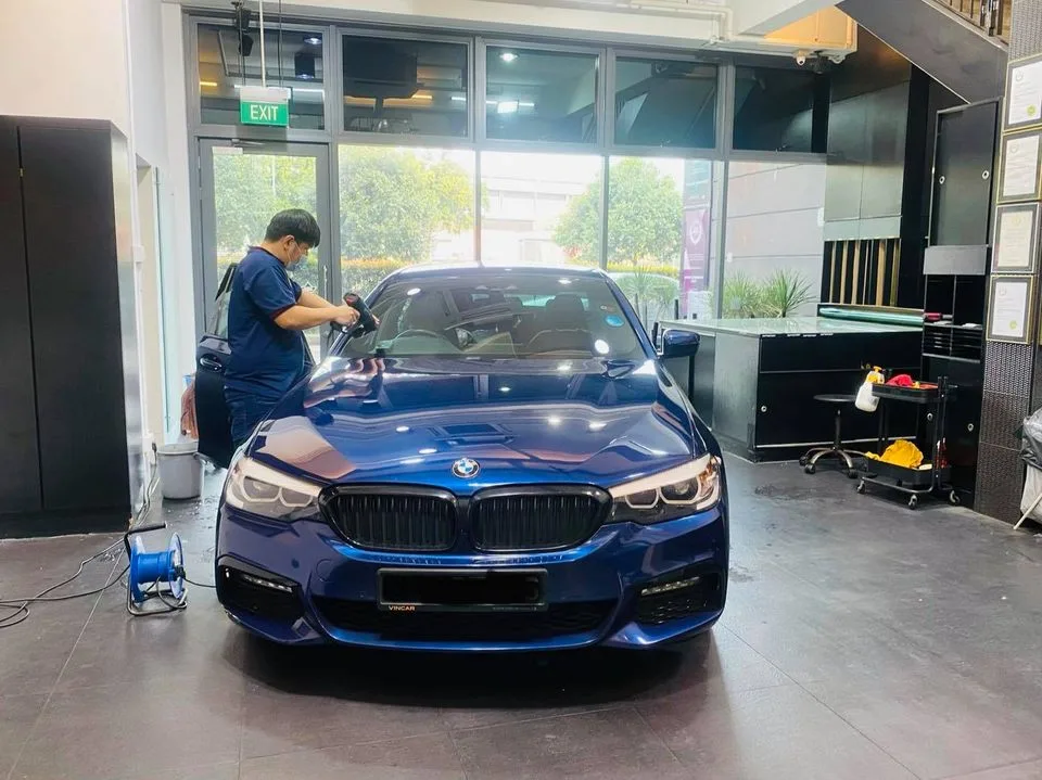 Blue BMW sedan having its windscreen tinted at Infratint Singapore