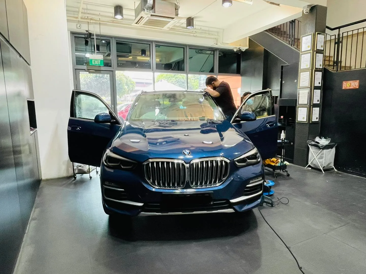 Dark blue BMW X5 SUV being tinted at the windscreen at Infratint Singapore