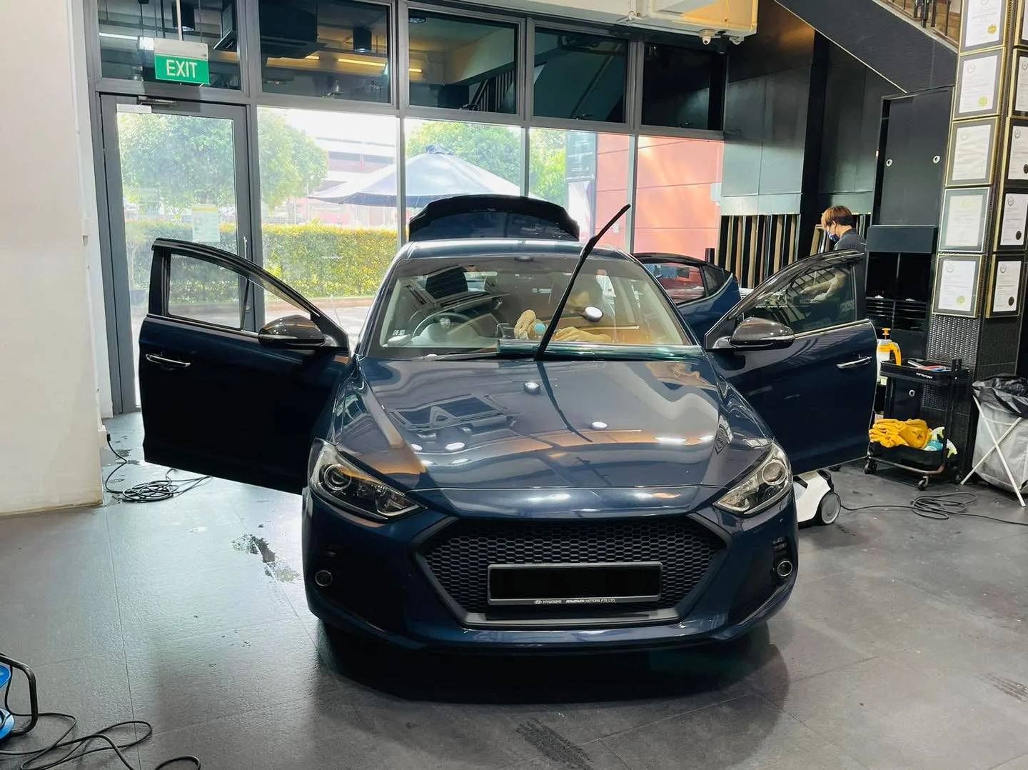 Dark blue Hyundai sedan with doors open at Infratint Singapore for window film
