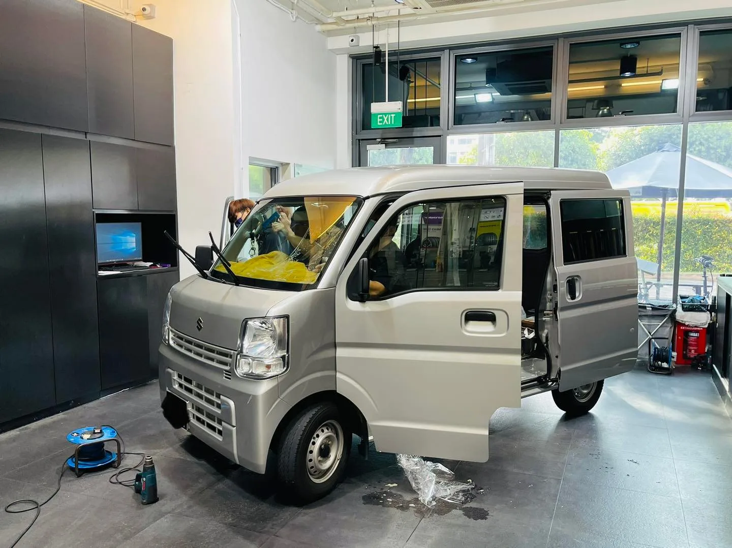 Silver Suzuki Every van during window film install at Infratint Singapore