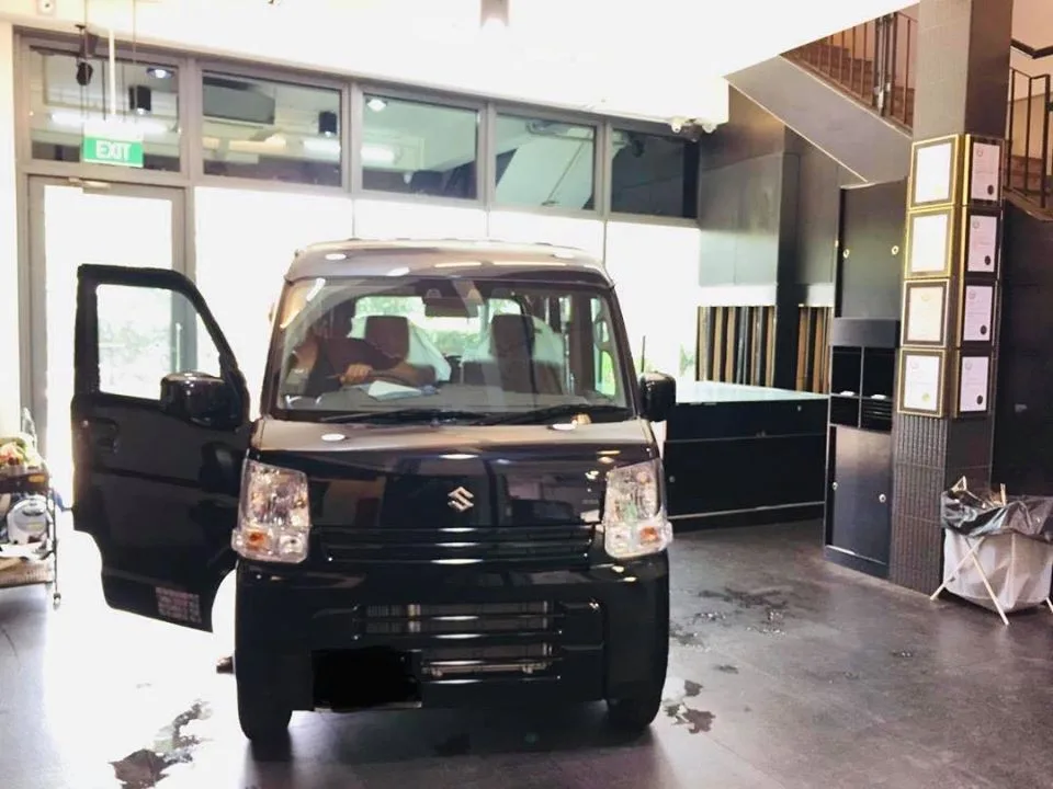 Black Suzuki van with door open during window tinting at Infratint Singapore