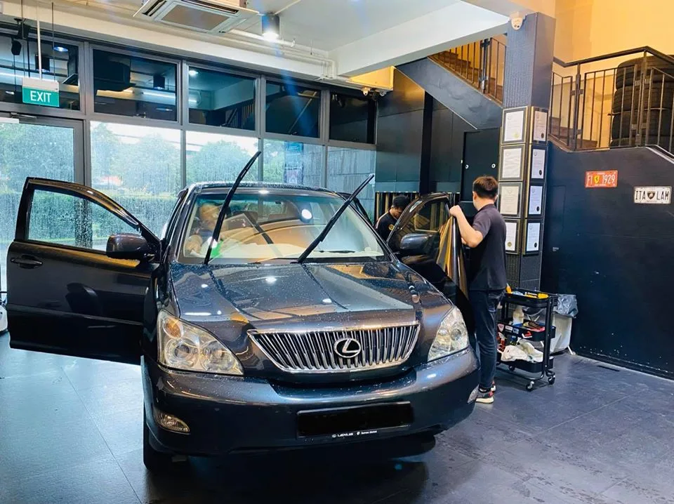 Grey Lexus SUV with doors open during window tinting at Infratint Singapore