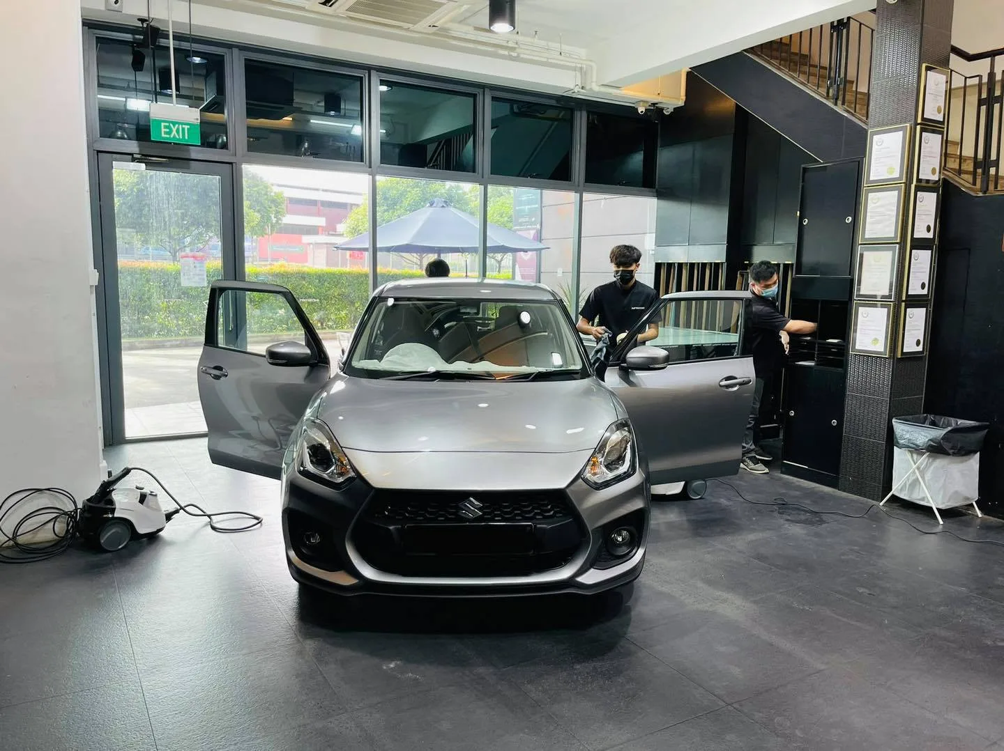 Silver Suzuki Swift with door open during window tinting at Infratint Singapore