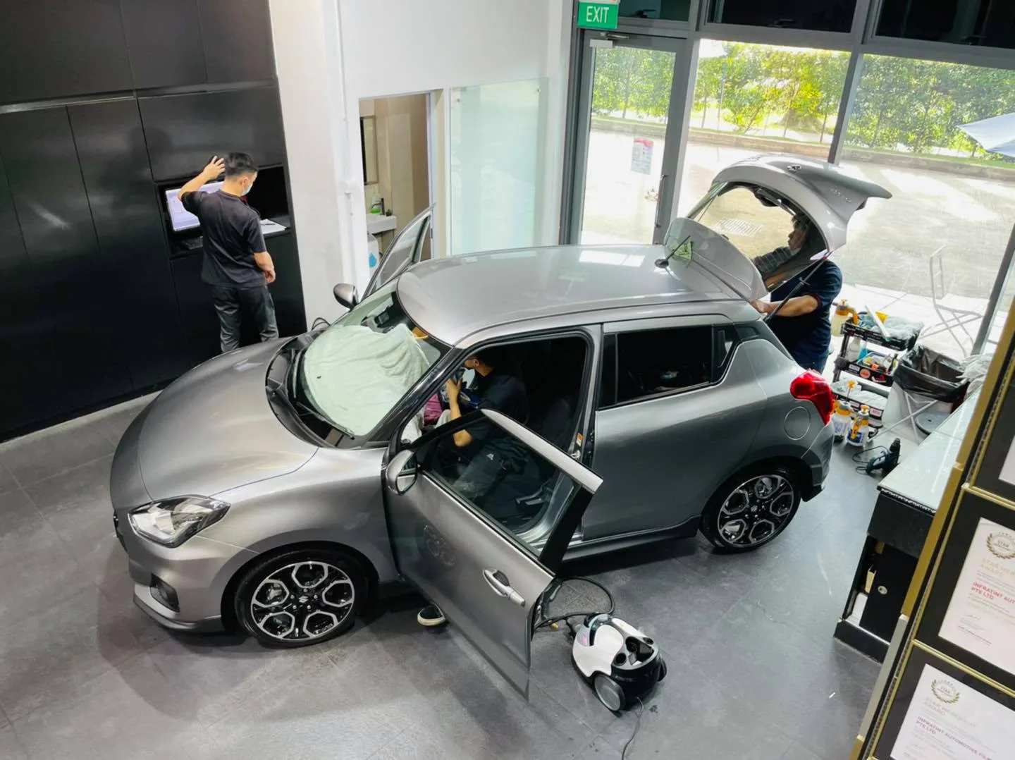 Overhead view of a Suzuki Swift being tinted with technicians at Infratint Singapore