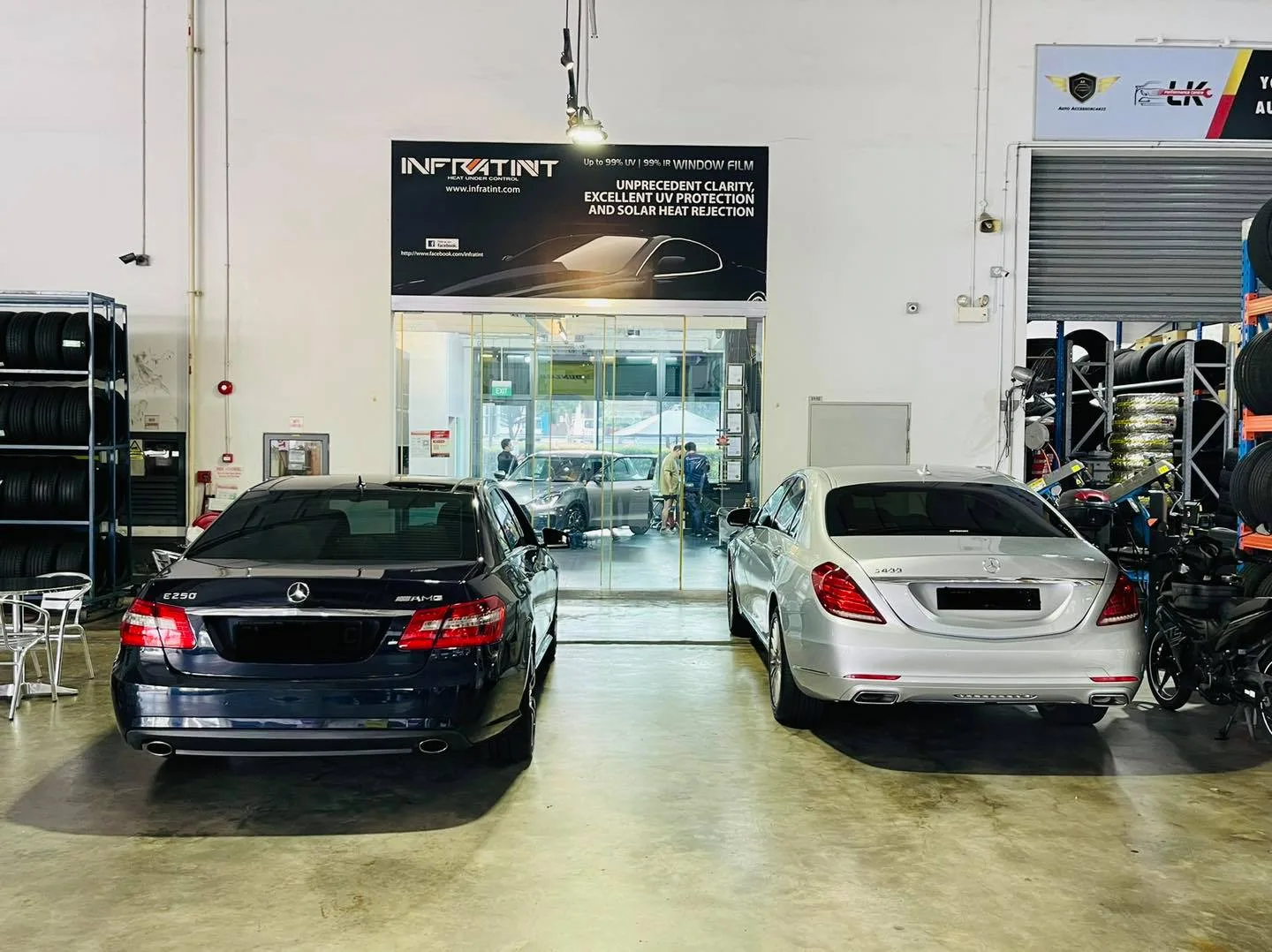 Two Mercedes-Benz cars inside the Infratint Singapore workshop awaiting solar film