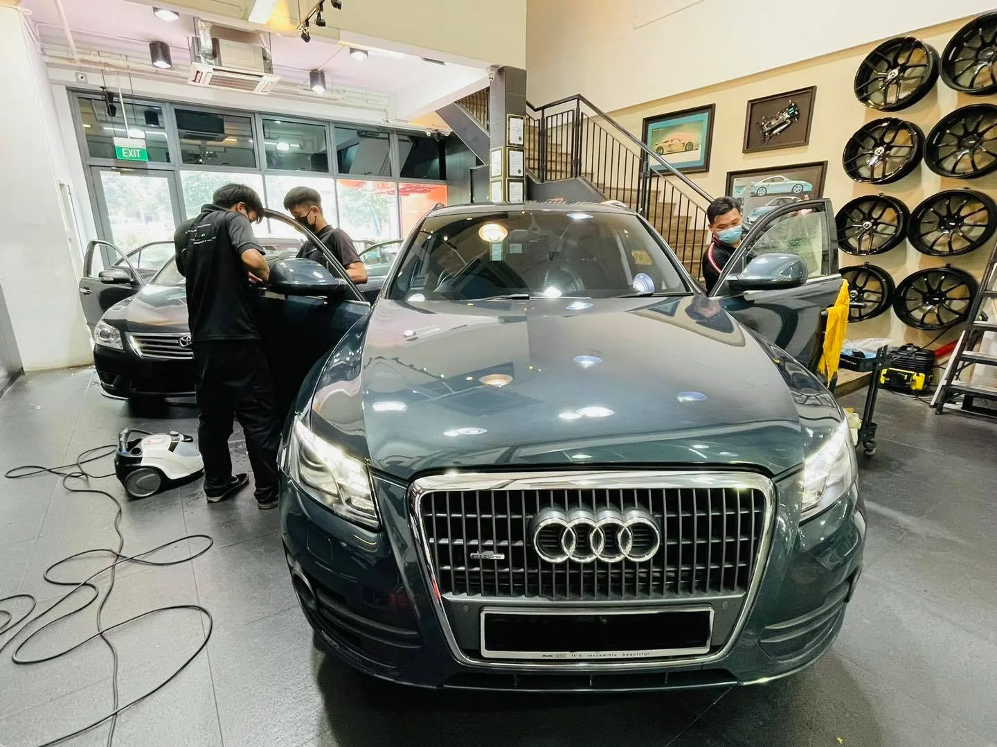 Dark green Audi Q5 with doors open during window tinting at Infratint Singapore
