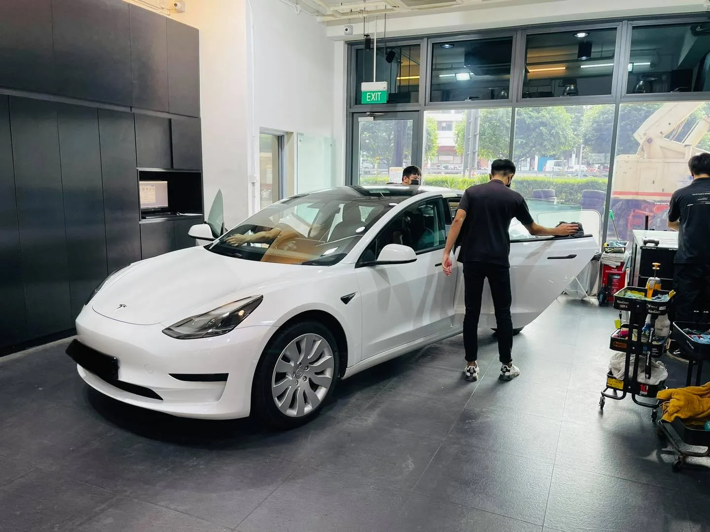 White Tesla Model 3 front three-quarter during window tinting at Infratint Singapore
