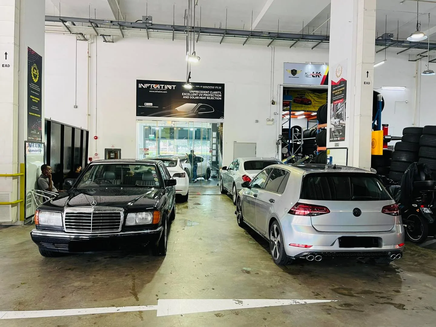 Black classic Mercedes-Benz and silver VW Golf at Infratint Singapore