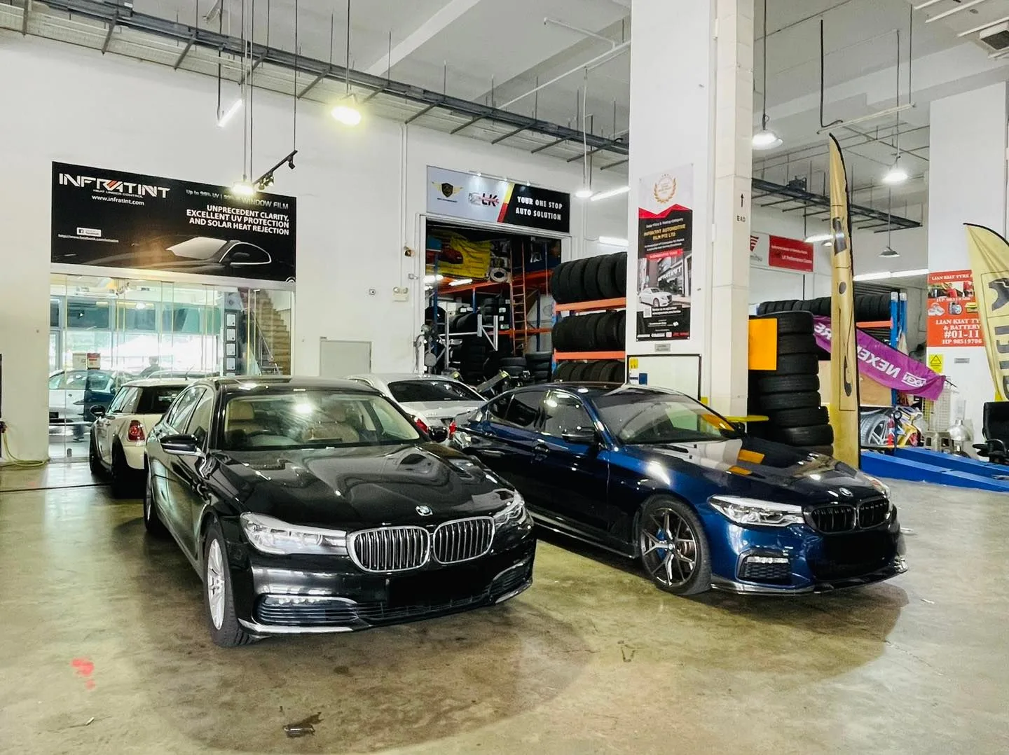 Black BMW 7 Series and blue BMW inside Infratint Singapore