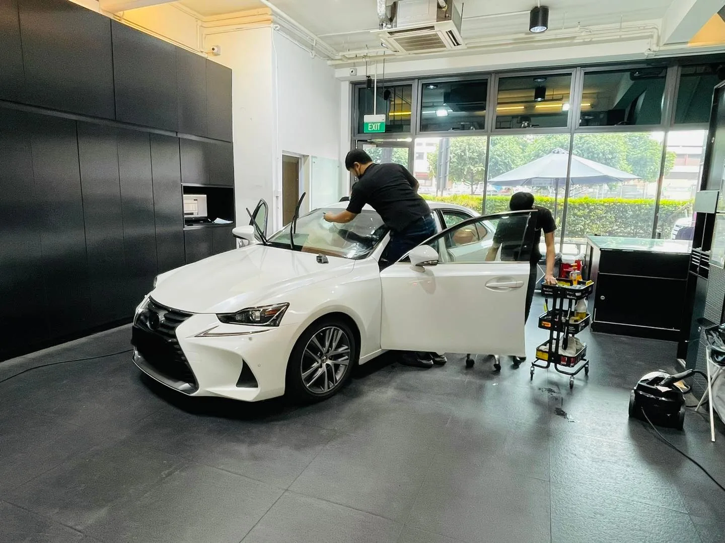 White Lexus IS front three-quarter during window tinting at Infratint Singapore